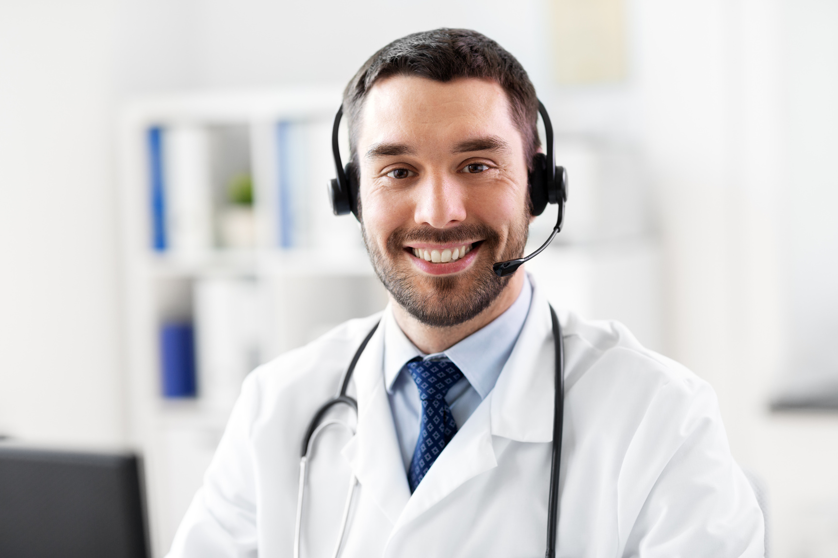 Happy Male Doctor with Headset at Hospital